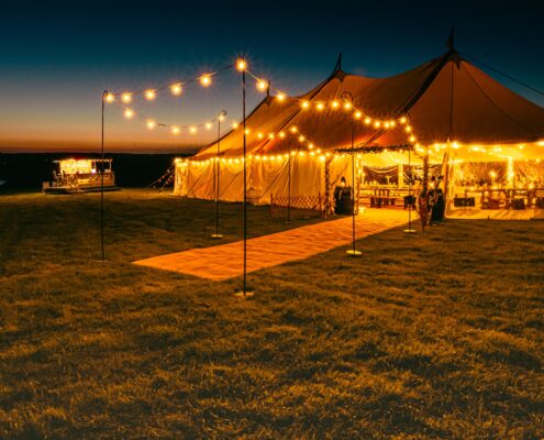 Traditional style Celeste Pole Sailcloth 12x24m Marquee beautifully Lit by Festoon lights